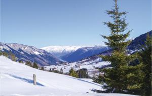 a christmas tree on a snow covered slope with mountains at Stunning Home In Vik I Sogn With Wifi in Espeset