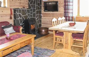 a living room with a table and a wood stove at Stunning Home In Vik I Sogn With Wifi in Espeset +7 photos