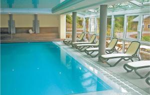 a swimming pool with lounge chairs and a swimming pool at Stunning Apartment In Bllingen With Kitchen in Bullange