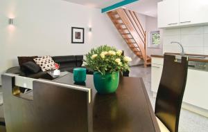 a kitchen and living room with a table with flowers on it at Cozy Home In Pinnow With Kitchenette in Petersberg