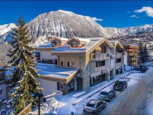 a house in the mountains with cars parked in the snow at Appartement Courchevel 1550, 3 pièces, 4 personnes - FR-1-664-5 in Courchevel