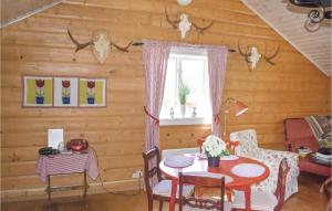 a dining room with a table in a log cabin at Stunning Home In Sankt Anna With 2 Bedrooms And Wifi in Sankt Anna