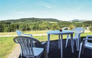 a table and chairs on a patio with a view at Lovely Home In Gerolstein With Wifi in Gerolstein