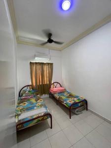 バヤンレパスにあるNORISH HOMESTAYのベッド2台と天井が備わる客室です。 +2枚の写真