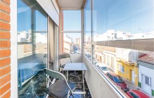 a balcony with two chairs and a table in a building at Stunning Apartment In Torrevieja in Torrevieja