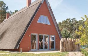 a red house with a thatched roof at Stunning Home In Loddin With Kitchen in Loddin