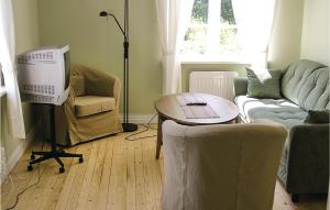 a living room with a couch and a table at 1 Bedroom Cozy Home In Vimmerby in Vimmerby