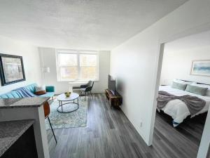 a bedroom with a bed and a desk and a table at Sleepover Downtown Cincinnati 1BD 1BA Apartments in Cincinnati