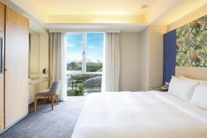 Rúm í herbergi á Dandy Hotel-Daan Park Branch