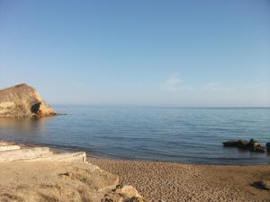 a beach with rocks and the ocean on a sunny day at Apartment Timpirussimare in Sciacca