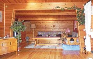 a log cabin with a bed in a room at Three-Bedroom Holiday Home With A Fireplace In Grisslehamn in Grisslehamn +12 photos