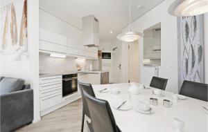 eine Küche und ein Esszimmer mit einem weißen Tisch und Stühlen in der Unterkunft Highend Travemünde - Whg 202 in Travemünde