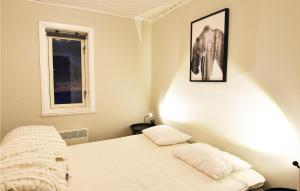 a small bedroom with a bed and a window at Cozy Home In Sysslebck With Kitchen in Branäs