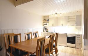 ブラネースにあるNice Home In Sysslebck With 3 Bedrooms, Sauna And Wifiのキッチン(木製テーブル、いくつかの椅子付)