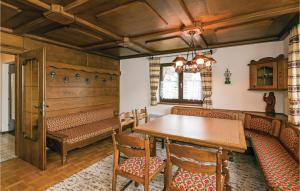 a dining room with a wooden table and chairs at Cozy Home In Gssing With Ethernet Internet in Güssing