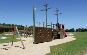 a park with a playground with a rock wall at Cozy Home In Gssing With Ethernet Internet in Güssing