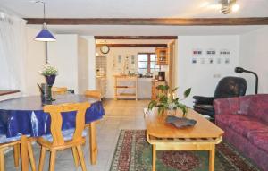 a living room with a table and a couch at Rddehof in Blentarp