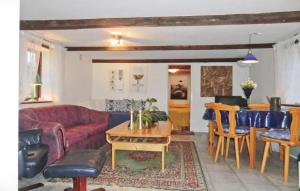 a living room with a red couch and a table at Röddehof in Blentarp