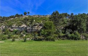 a green field with a hill with trees and a kite at 2 Bedroom Stunning Home In Merindol in Mérindol