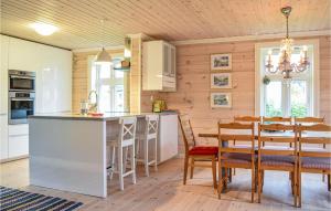 a kitchen and dining room with a table and chairs at Solvang in Harkestad