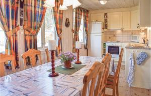 a kitchen with a dining room table with chairs and a tableablish at Beautiful Home In Risør With Kitchen in Songe