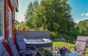 a patio with chairs and a table and a couch at Beautiful Home In Risør With Kitchen in Songe