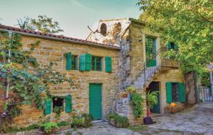 an old stone house with green shutters at 2 Bedroom Nice Home In Smarje in Pomjan +22 photos