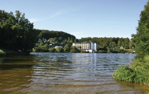 a view of a river with a building in the background at Ferienhaus 107 In Kirchheim in Kemmerode