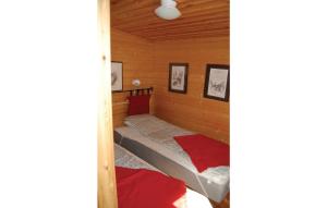 a small bedroom with a bed in a cabin at Beautiful Home In Svanskog With 2 Bedrooms And Sauna in Slirud