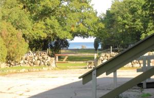a stairway leading to a park with a rock wall at 2 Bedroom Amazing Home In Jämjö in Torhamn +12 photos