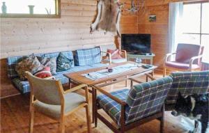 uma sala de estar com um sofá, uma mesa e cadeiras em Bjrgan Grd em Vannvikan
