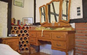 a bedroom with a wooden dresser with a mirror at Beautiful Apartment In Reifferscheid in Reifferscheid +9 photos