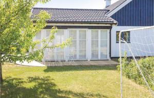 a house with a deck and a soccer goal at Nice Home In Ystad With 4 Bedrooms And Wifi in Ystad