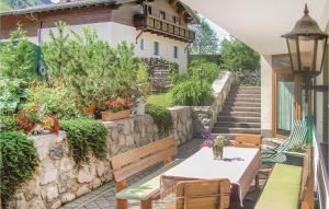 a patio with a table and chairs and a building at Beautiful Apartment In Kleinarl With 3 Bedrooms And Wifi in Kleinarl