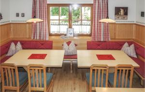 a restaurant with two tables and a red couch at Beautiful Apartment In Kleinarl With 3 Bedrooms And Wifi in Kleinarl