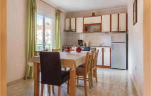 a kitchen with a table and chairs in a room at Beautiful Apartment In Raslina With Wifi in Raslina