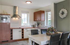 a kitchen with a table and chairs in a kitchen at 3 Bedroom Cozy Home In Wemeldinge in Wemeldinge