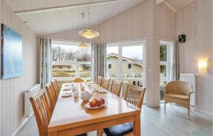a dining room with a table and chairs at Frische Brise 18 - Dorf 3 in Priwall