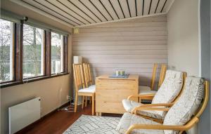 a room with two chairs and a table and windows at Stunning Home In Ambjörnarp in Ambjörnarp
