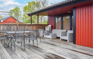 a deck with chairs and a table and chairs at Holiday Home Öjvägen Köpingsvik in Köpingsvik