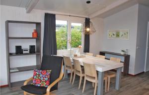 a kitchen and dining room with a table and chairs at 2 Bedroom Awesome Home In Sint-annaland in Sint Annaland
