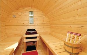 a small wooden sauna with a stove in it at Cozy Home In Zerpenschleuse With Sauna in Zerpenschleuse