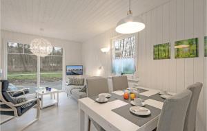 una sala de estar blanca con mesa y sillas en Cozy Home In Zerpenschleuse With Sauna en Zerpenschleuse