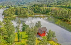 an aerial view of a small red house in the middle of a river at 3 Bedroom Amazing Home In Sandane in Sandane