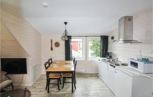 a kitchen with a table and chairs in a room at Beautiful Apartment In Hauge I Dalane With Kitchen in Åmot