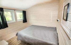 a bedroom with a bed in the corner of a room at Beautiful Apartment In Hauge I Dalane With Kitchen in Åmot