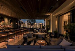 a lobby with couches and tables and a bar at Kimpton La Peer Hotel West Hollywood, an IHG Hotel in Los Angeles
