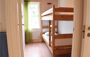 a room with two bunk beds and a window at 3 Bedroom Stunning Home In Slite in Slite