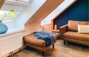 a living room with a couch and a chair at Stunning Apartment In Schagerbrug in Schagerbrug