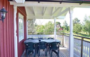 a porch with a table and chairs on it at Awesome Home In Svanskog With Wifi in Svanskog